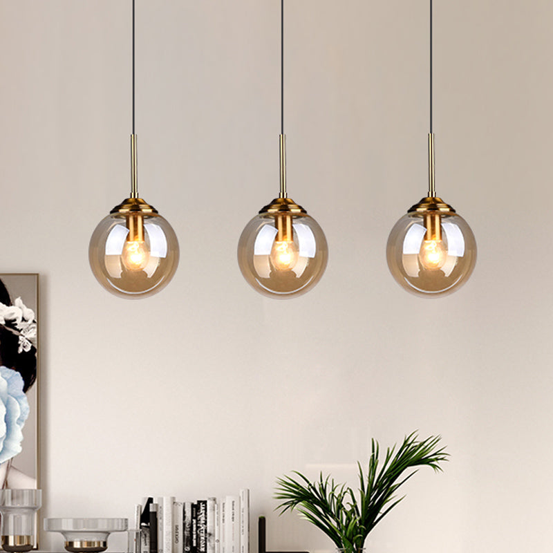 Sleek Brass Pendant Lamp With Amber/Smoke Glass Shade – Perfect For Dining Room Ceilings