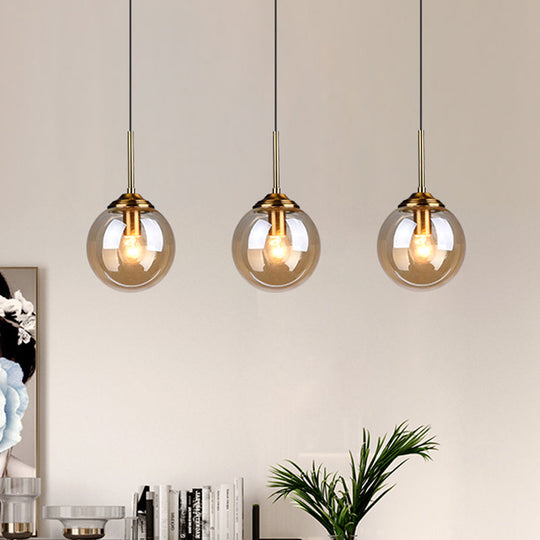 Sleek Brass Pendant Lamp With Amber/Smoke Glass Shade – Perfect For Dining Room Ceilings