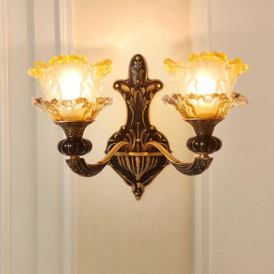 Rustic Half-Head Wall Lamp With Curvy Metallic Design And Flower Amber Glass Shade - Brass Finish