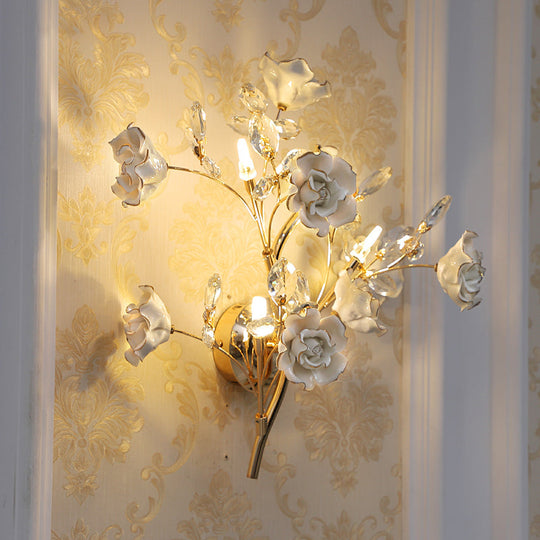 Contemporary Gold Crystal Wall Lamp With Teardrop Faceted Design And Ceramic Flower Accents - 3 Bulb