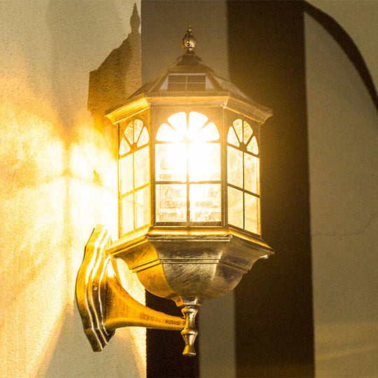 Traditional Outdoor Solar Wall Light Fixture With Metallic House Shaped Design And Clear Glass Shade