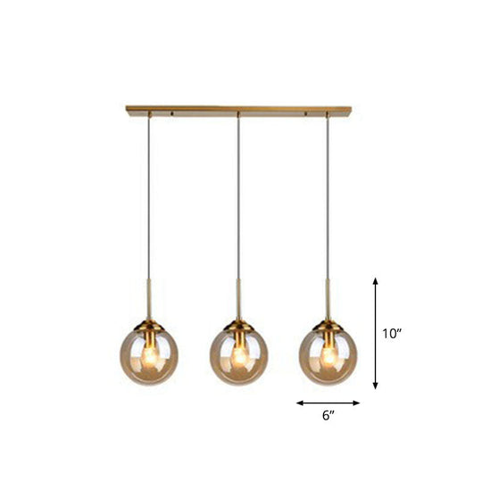 Sleek Glass 3-Bulb Spherical Ceiling Light Fixture In Brass For Minimalistic Dining Rooms