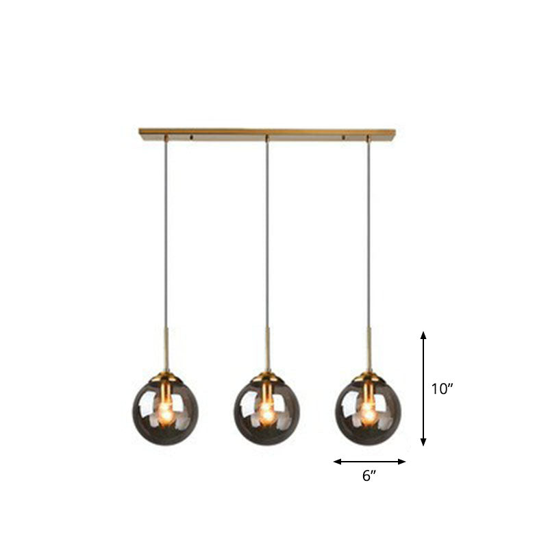 Sleek Glass 3-Bulb Spherical Ceiling Light Fixture In Brass For Minimalistic Dining Rooms