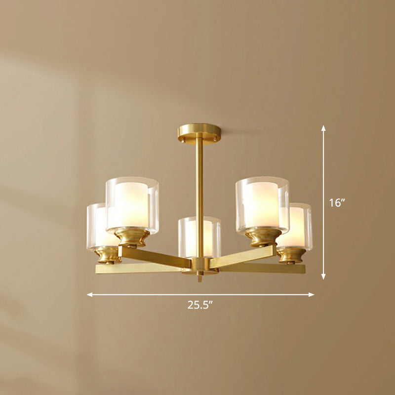 Sleek Brass Cylindrical Hanging Lamp With Clear And Frosted Glass Minimalistic Dining Room