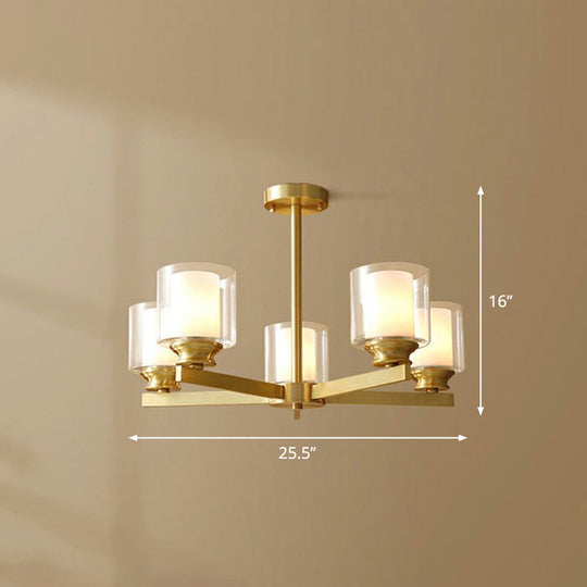 Sleek Brass Cylindrical Hanging Lamp With Clear And Frosted Glass Minimalistic Dining Room