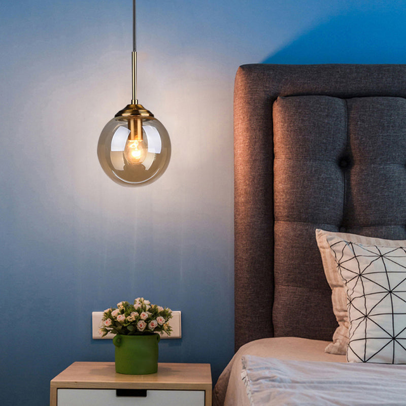 Brass Bedside Pendant Light: Postmodern Blown Glass Sphere | 1-Bulb Hanging Ceiling Fixture Amber