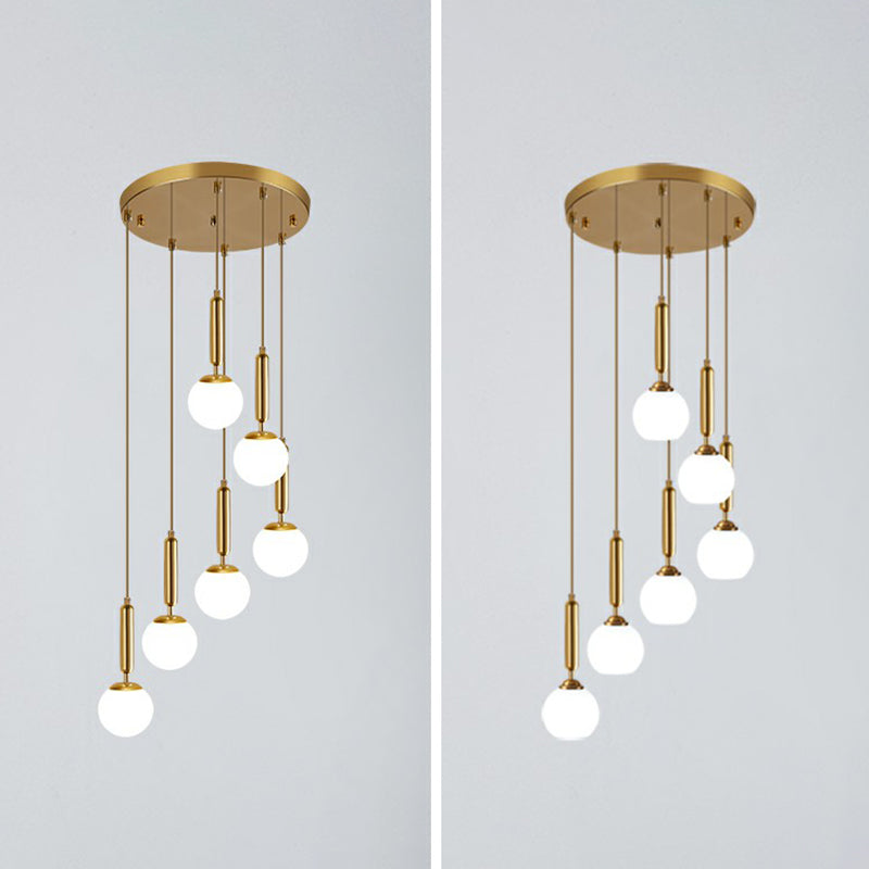 Gold Multi Hanging Stairway Light With Minimalist White Glass Ball Pendant