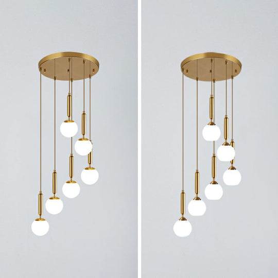 Gold Multi Hanging Stairway Light With Minimalist White Glass Ball Pendant