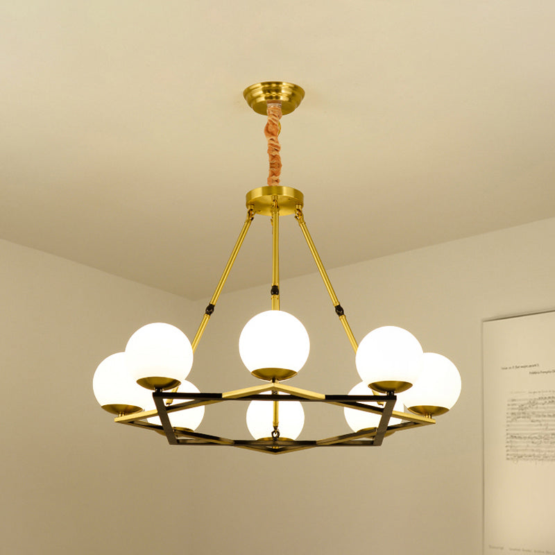 Postmodern Polygon Metal Chandelier With Brass Finish And Globe White Glass Shades