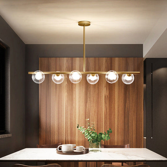 Nordic Metal 6-Head Linear Island Light With Gold Finish And Clear Glass Globes