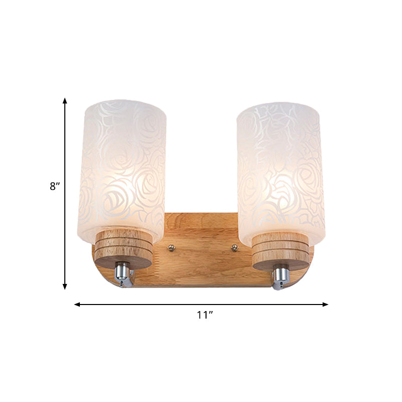 Modern 2-Headed White Glass Cylinder Wall Sconce With Wood Mount And Rose Pattern