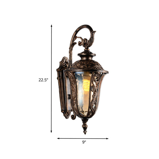 Bronze Metal Outdoor Wall Sconce With Curved Arm Amber Glass Shade - 1-Light Lamp