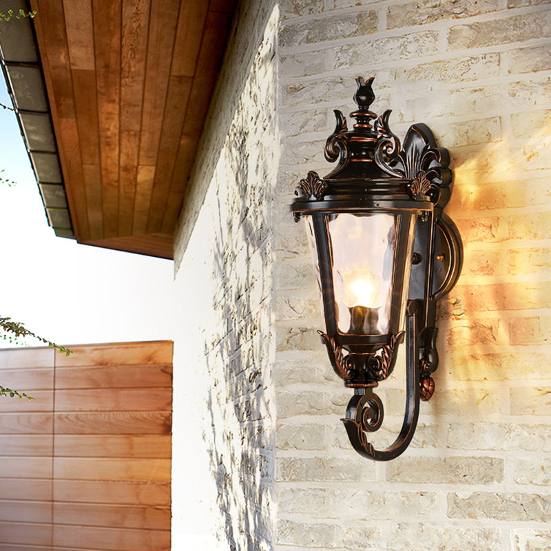 Clear Water Glass Outdoor Wall Sconce: Scrolled Arm 1-Light Black & Gold Lodge Lighting