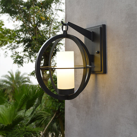Rustic Black Cylinder Sconce With Frosted Glass And Metal Cage