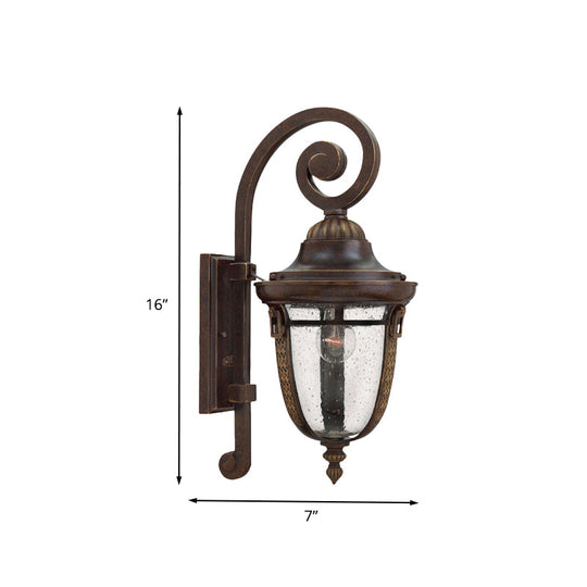Rustic Bronze Scrolling Arm Metal Wall Lamp - 1 Light Outdoor Sconce With Seedy Glass Shade