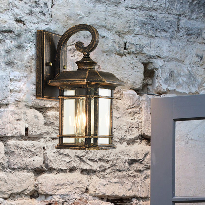 Bronze Curvy Arm Outdoor Wall Sconce With Clear Ripple Glass