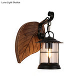 Antiqued Kerosene Wall Sconce With Clear Glass And Wood Leaf/Key Backplate For Dining Room Lighting