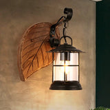 Antiqued Kerosene Wall Sconce With Clear Glass And Wood Leaf/Key Backplate For Dining Room Lighting