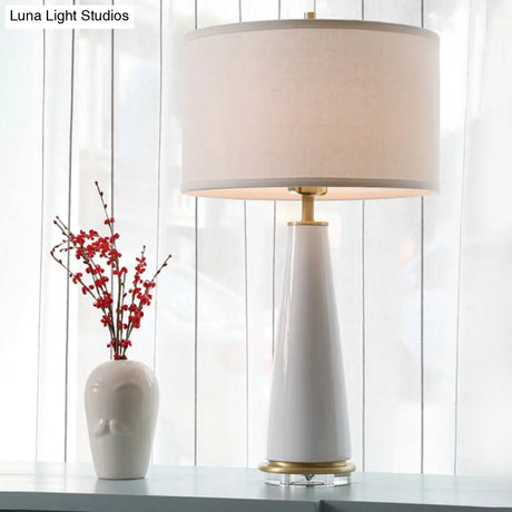 Modern White Fabric Cylinder Table Light With Cone Ceramic Base - 1 Bulb Desk Lamp