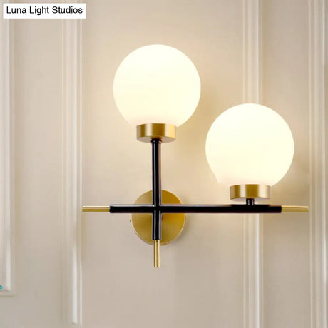 Post-Modern White Glass Sphere Wall Sconce With Brass Finish - 1/2 Bulbs
