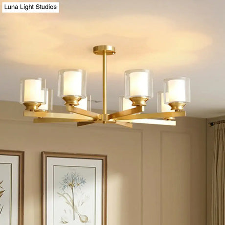 Sleek Brass Cylindrical Hanging Lamp With Clear And Frosted Glass Minimalistic Dining Room