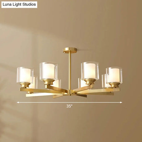 Sleek Brass Cylindrical Hanging Lamp With Clear And Frosted Glass Minimalistic Dining Room
