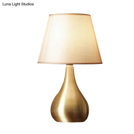 Sleek Metallic Urn-Shape Table Light - Simplicity 1-Light Brass Finish Lamp With Barrel Fabric Shade